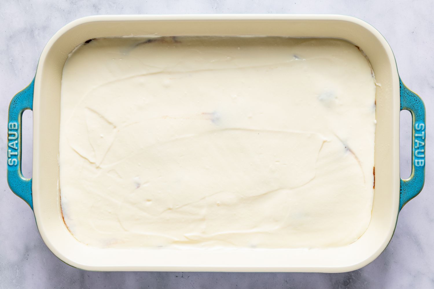 Layered cake batter in a rectangular baking dish with handles for Italian love cake recipe