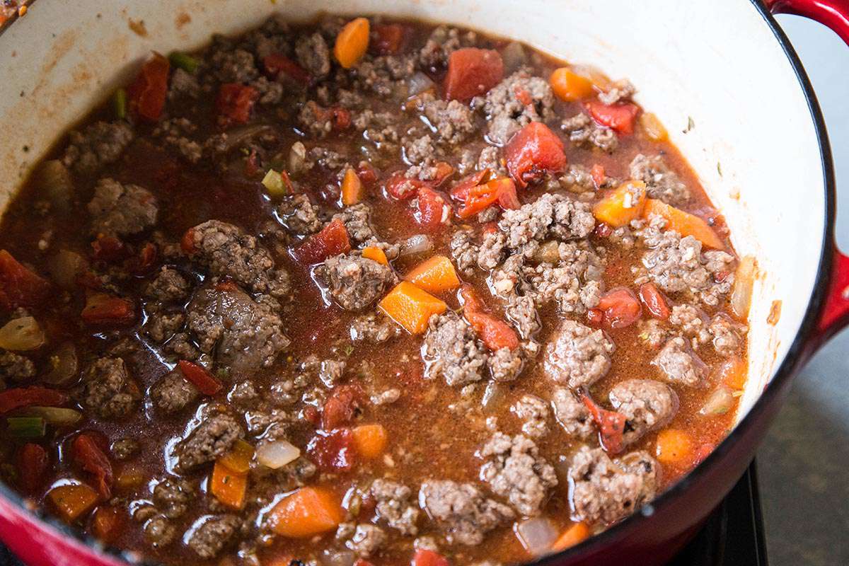 Hamburger soup ingredients simmering in pot