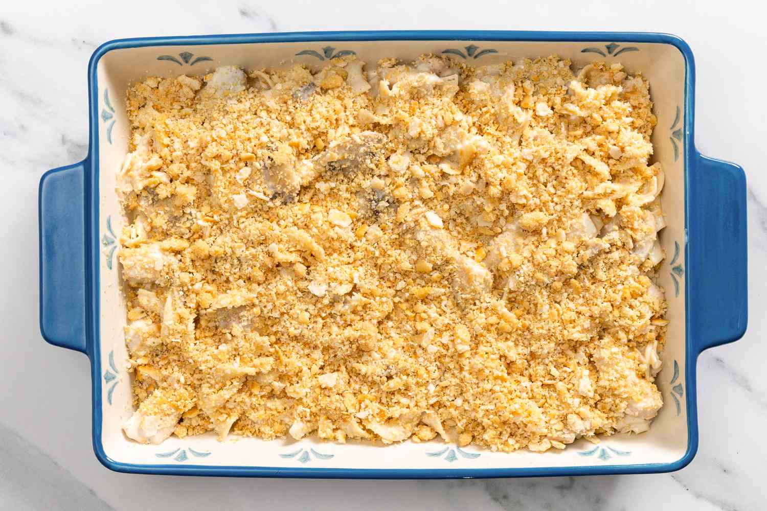 casserole mixture added to a baking dish, cracker crumbs mixture added to the top for Church Chicken Casserole