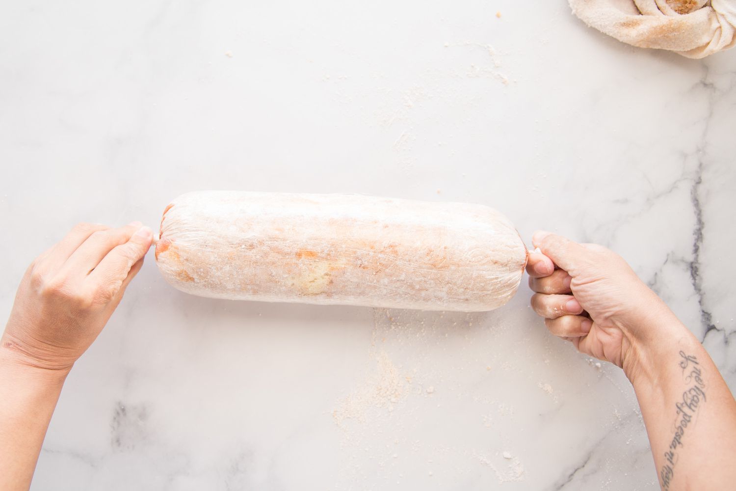 Wrapped Roll Cake with Guava Jelly in parchment to chill in refrigerator.
