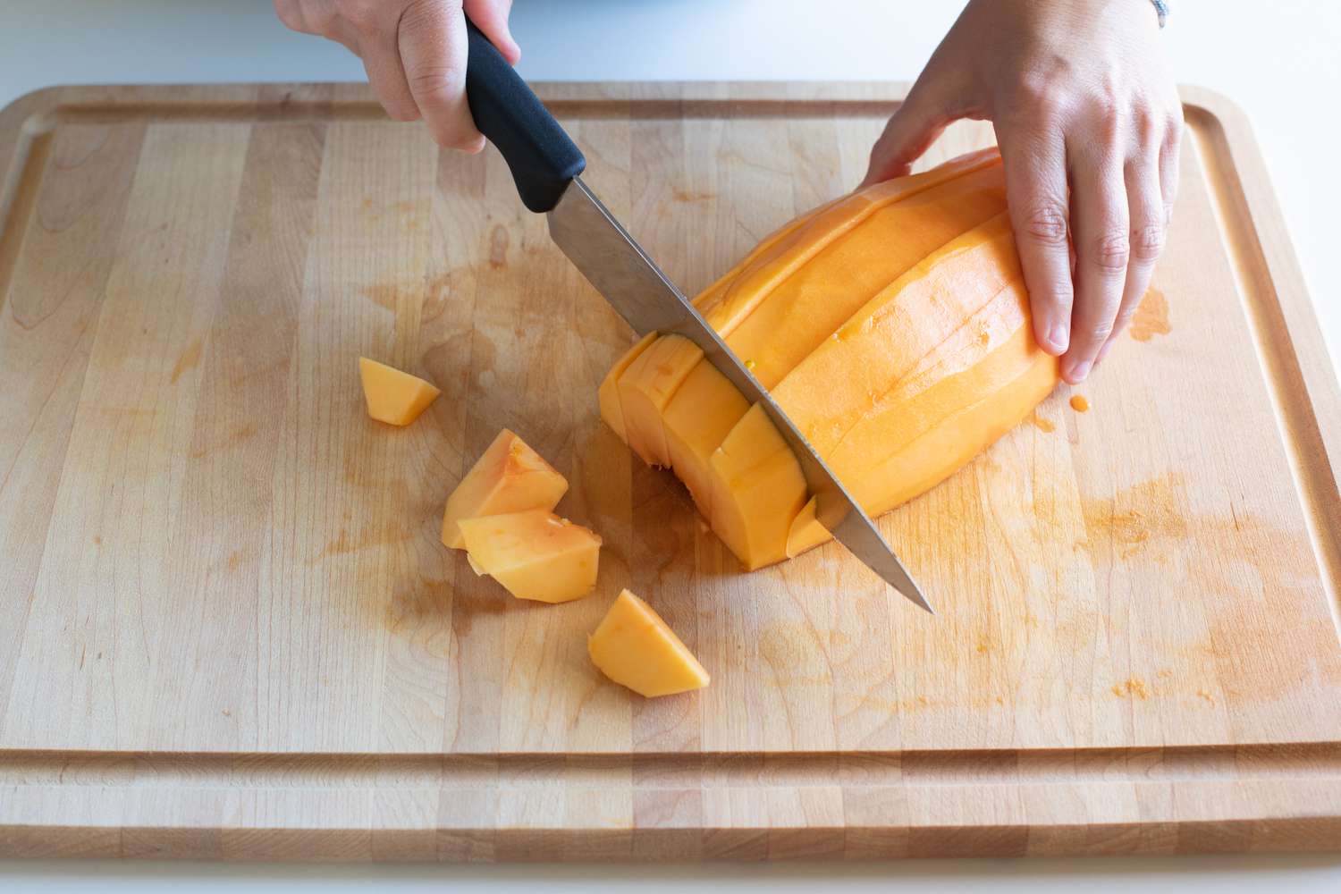 Cutting cubes of papaya