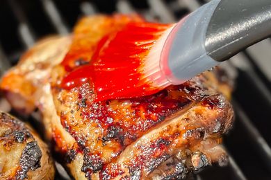 Grilled chicken with paste being brushed on
