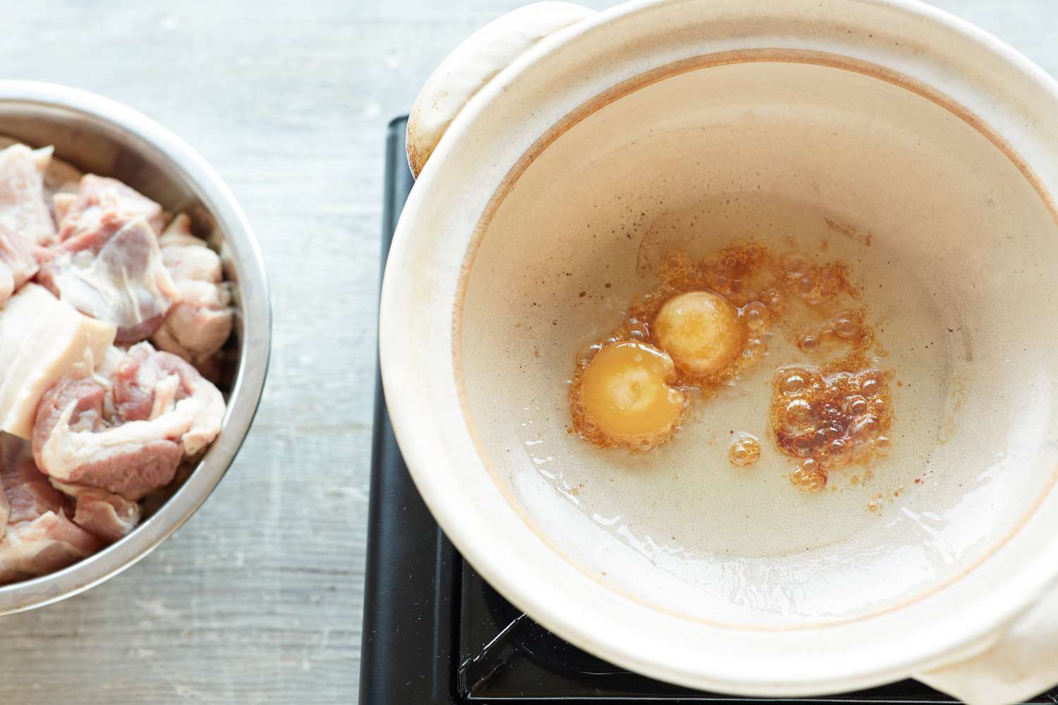 Palm oil and sugar in a pot to make Vietnamese braised pork belly and eggs 
