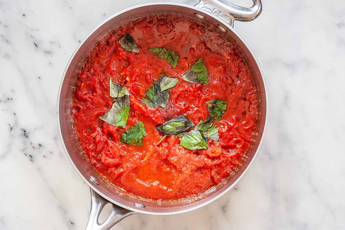 Homemade Tomato Sauce - basil with tomato sauce in pan