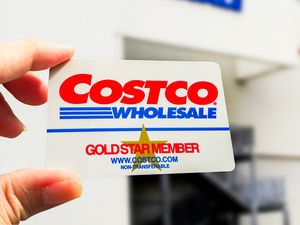 Costco membership card being held in front of a store entrance