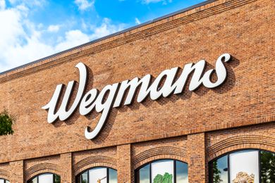 Wegmans store front and sign with cloudy skies overhead