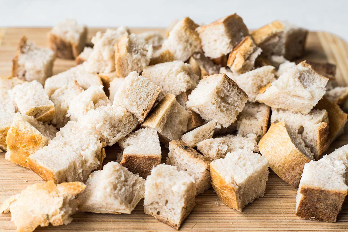 A pile of bread cubes on a cutting board