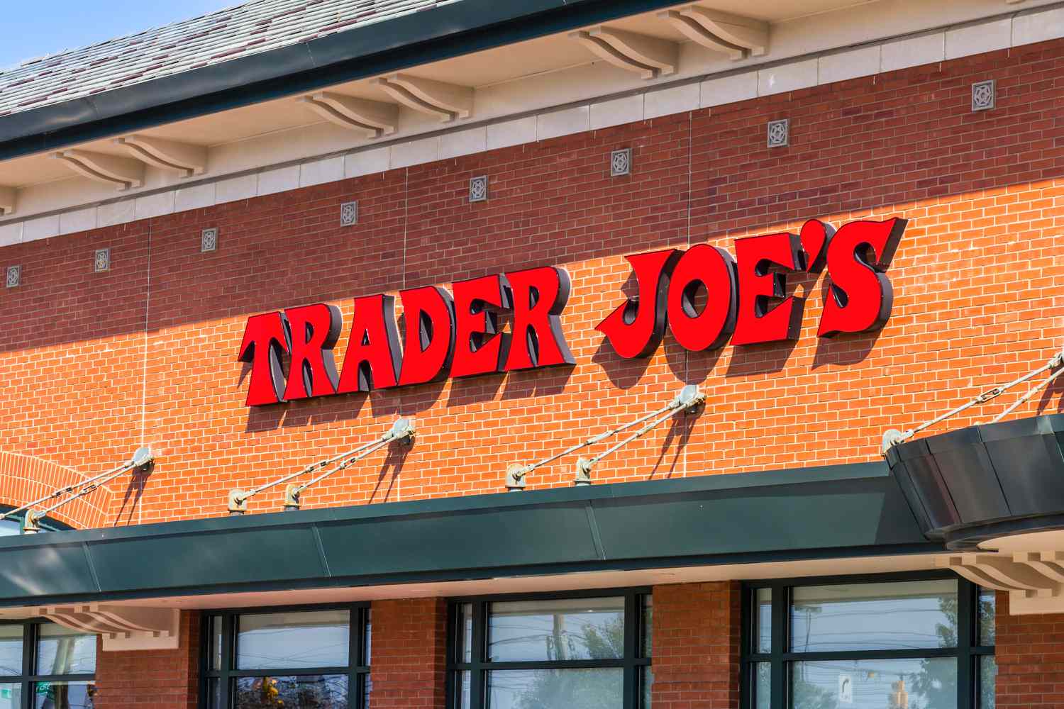 Ground level view of a Trader Joe's store front sign