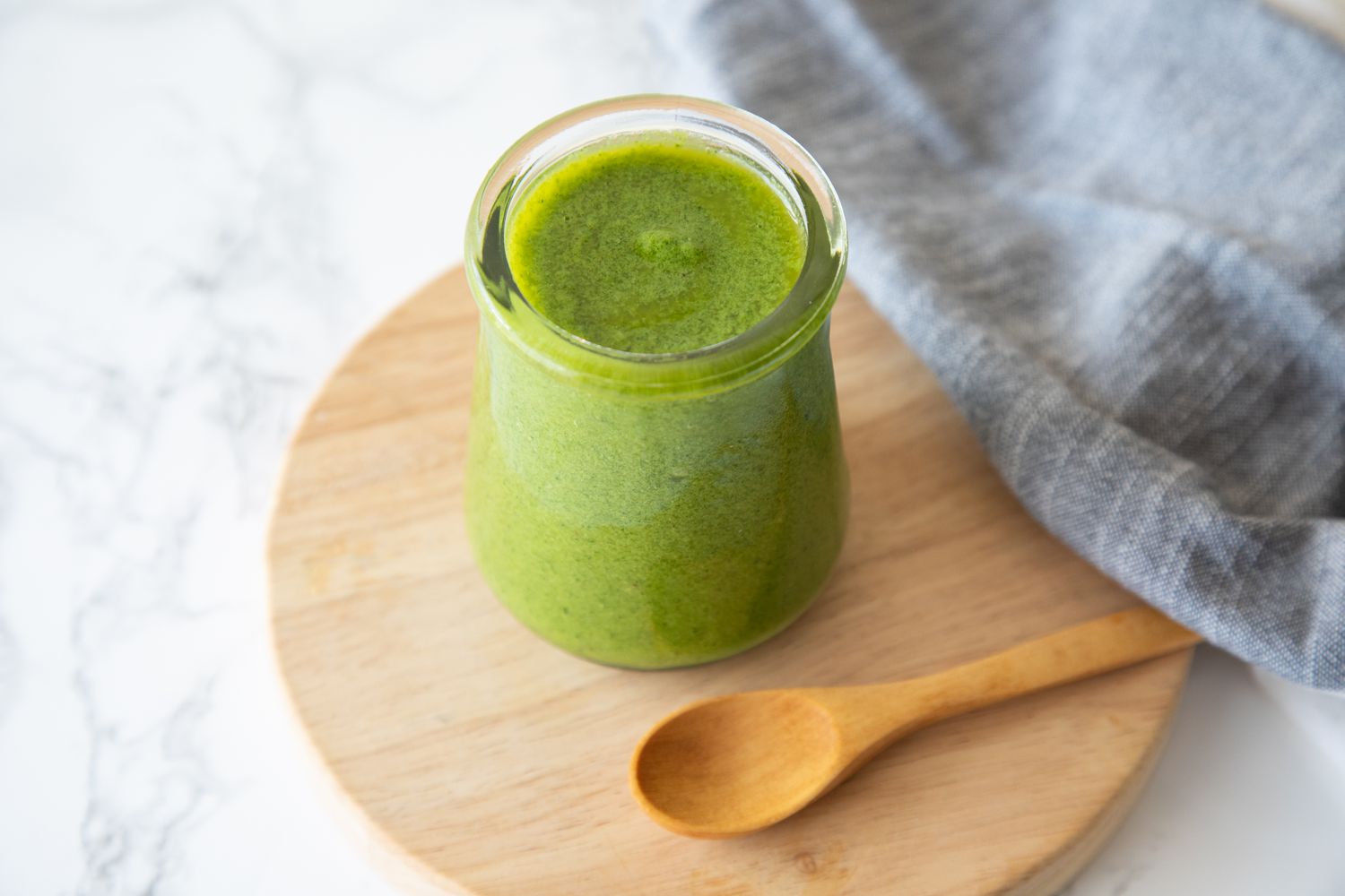 Avocado Lime Dressing on Wooden Tray Next to a Spoon