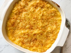 Overhead view of a baking dish of macaroni and cheese on a marble countertop