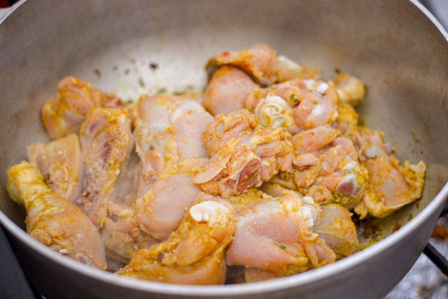 Seasoned Chicken Added to Curry Paste in Pot for Guyanese Curry Recipe