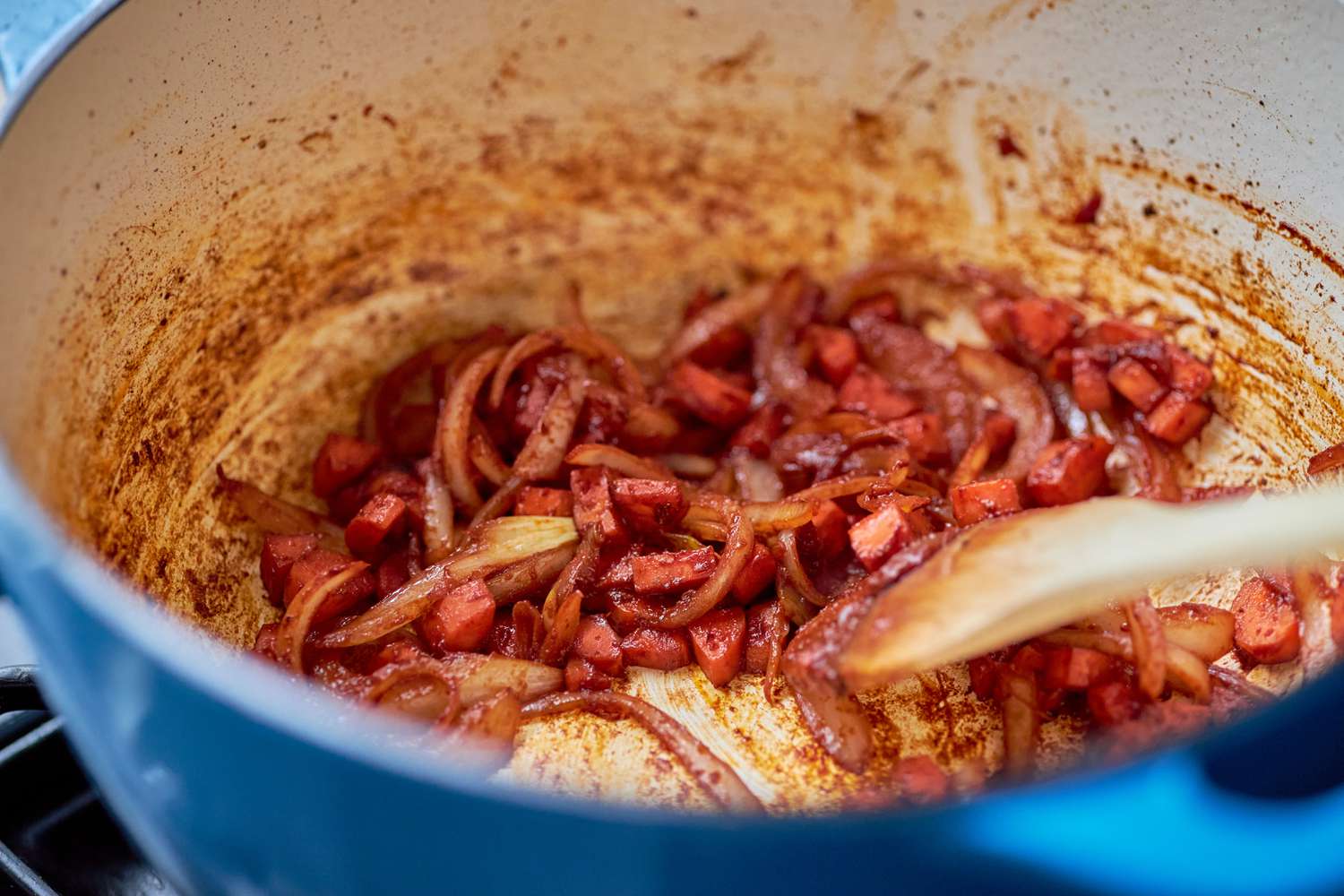 Onions and carrots cooked with tomato paste in the Dutch oven until tomato paste is dark brown for German rouladen recipe
