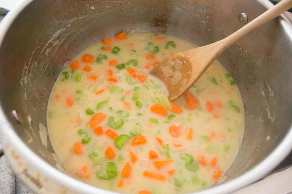 Creamy chicken dumpling soup in a stock pot.