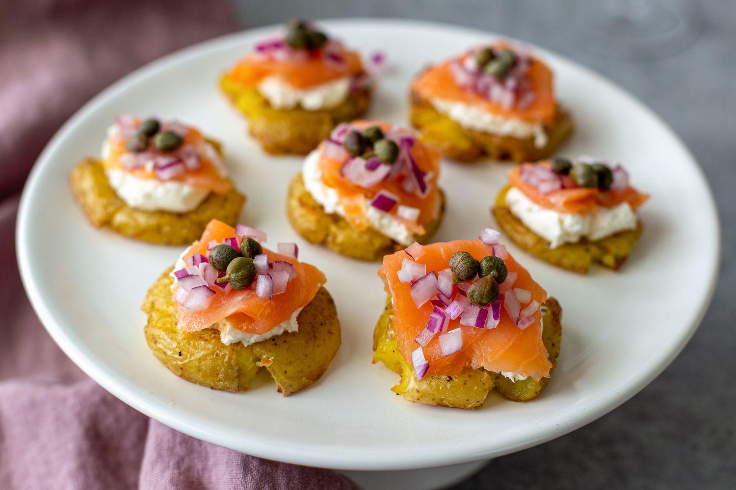 A platter of smoked salmon-topped potatoes.
