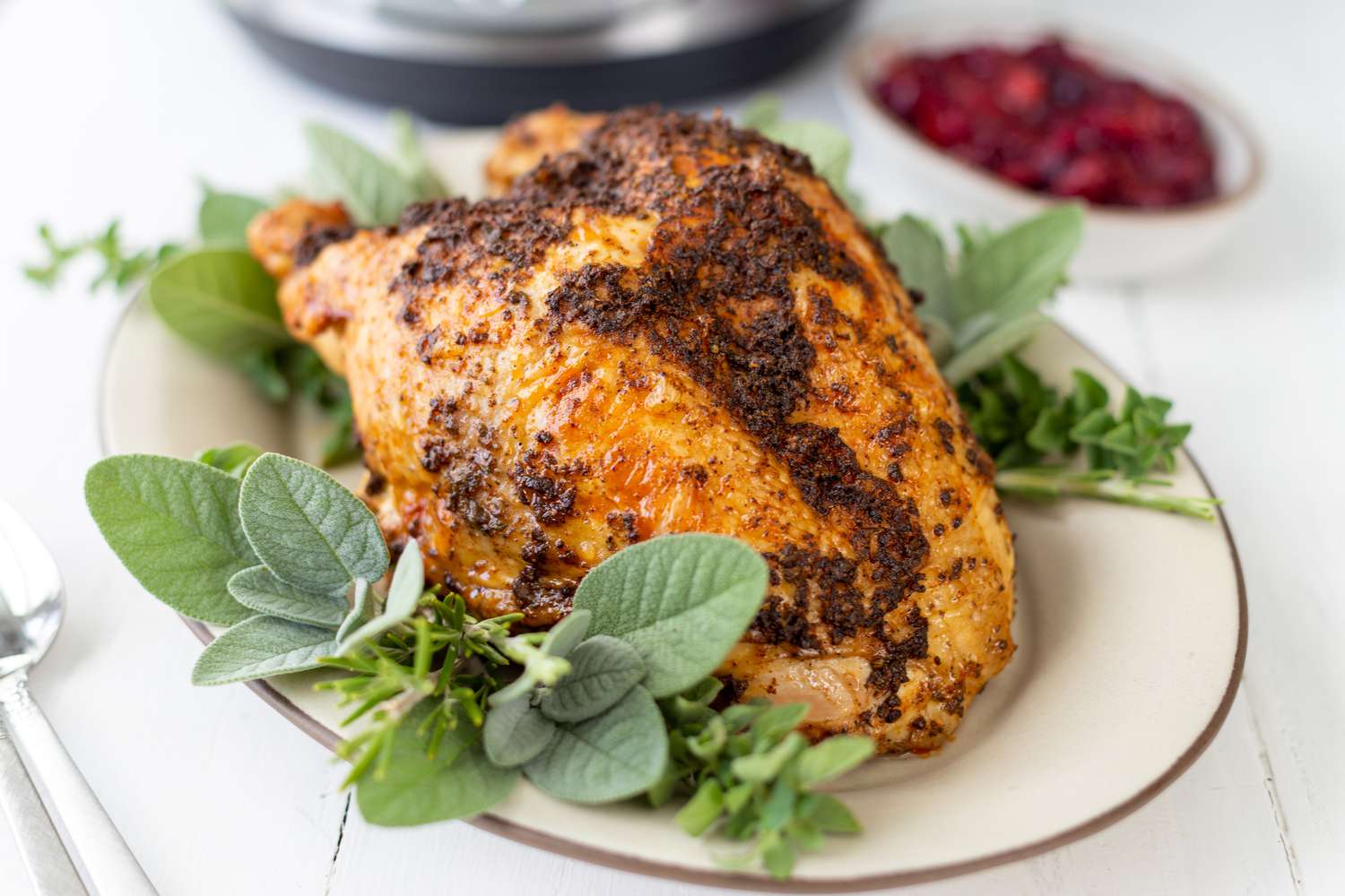 Quick and easy instant pot turkey breasts set on an herb covered platter.