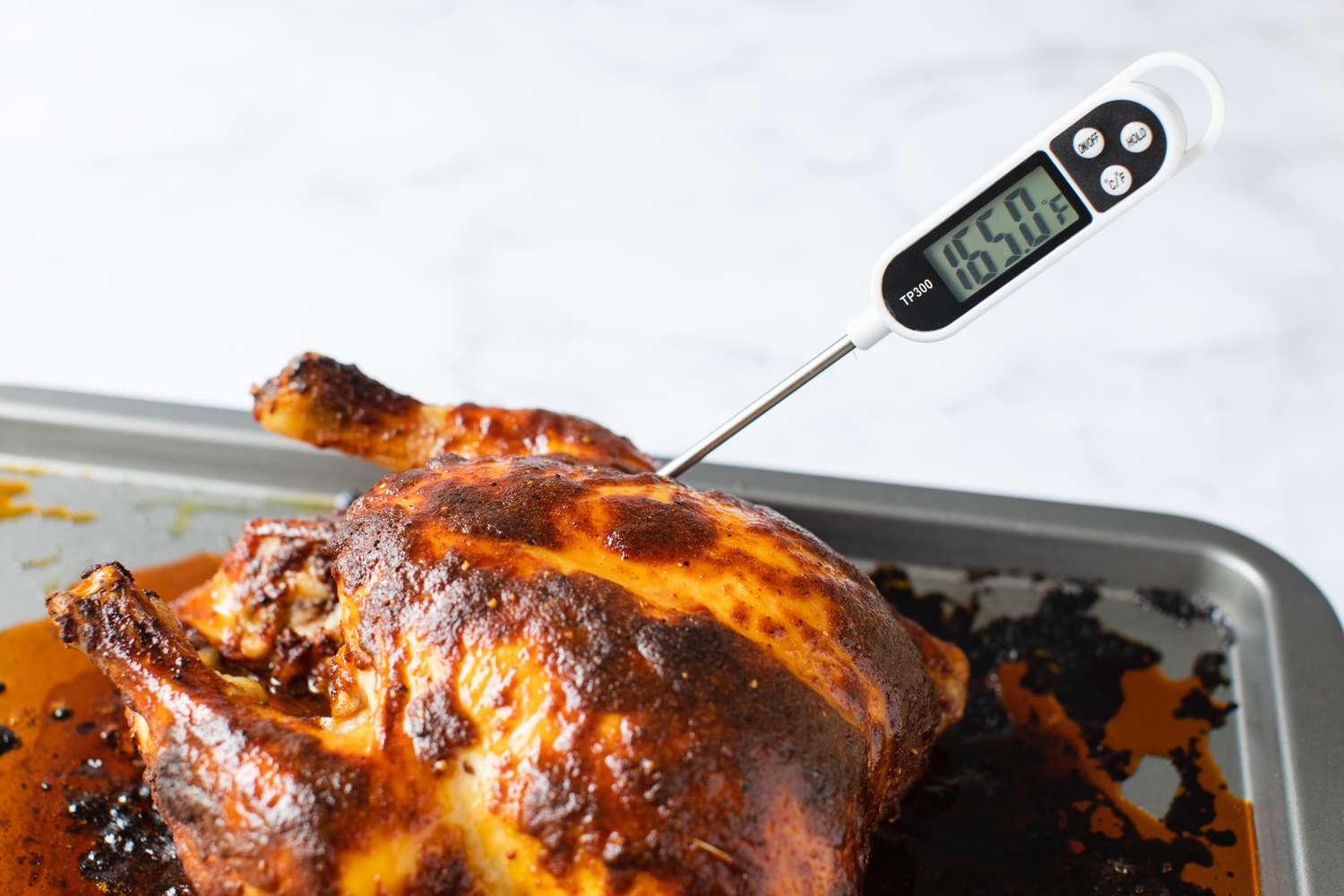 Thermometer Poked in Paprika Chicken to Get Internal Temperature