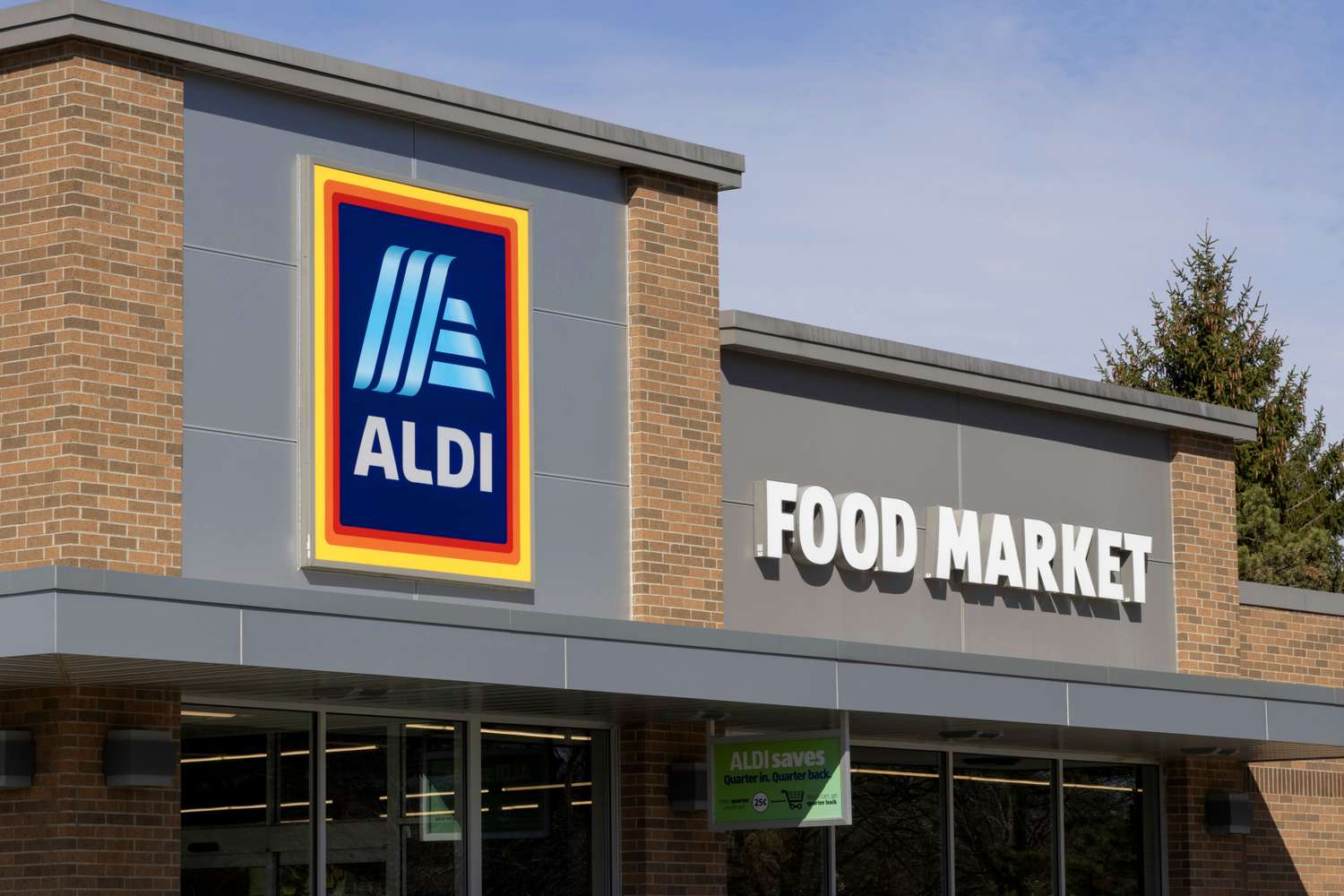 Exterior of an Aldi food market with logo sign and building entrance