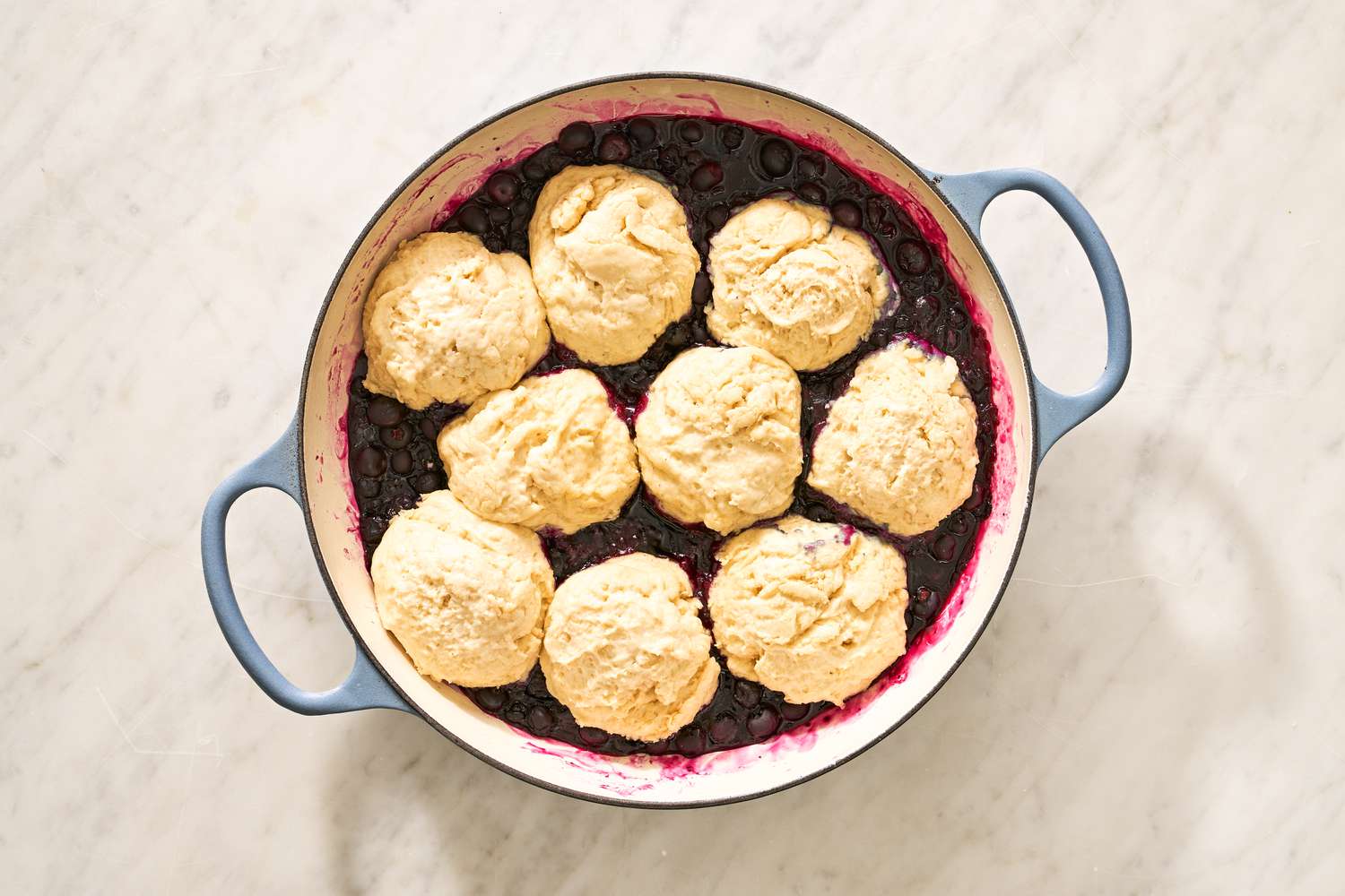 baked blueberry grunt in a braiser