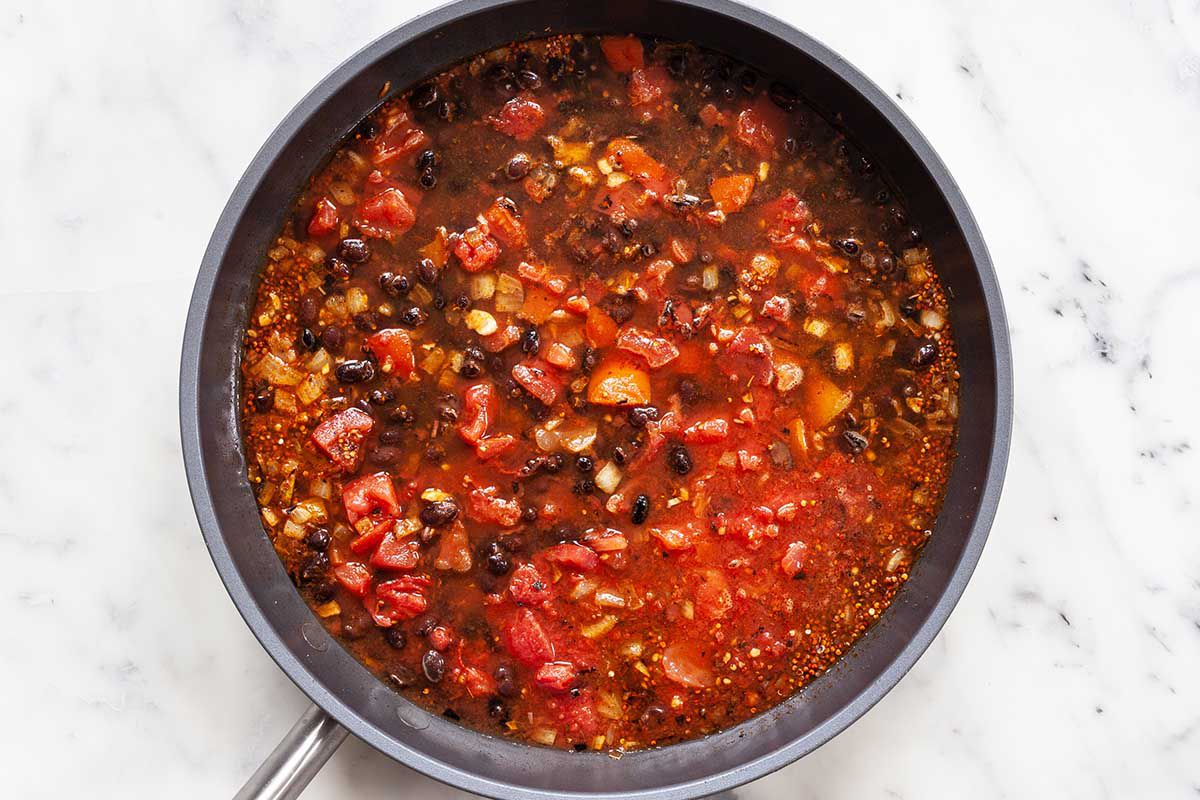 Black beans, tomatoes, butternut squash and spices mixed together in a saute pan for easy vegetarian skillet dinner.