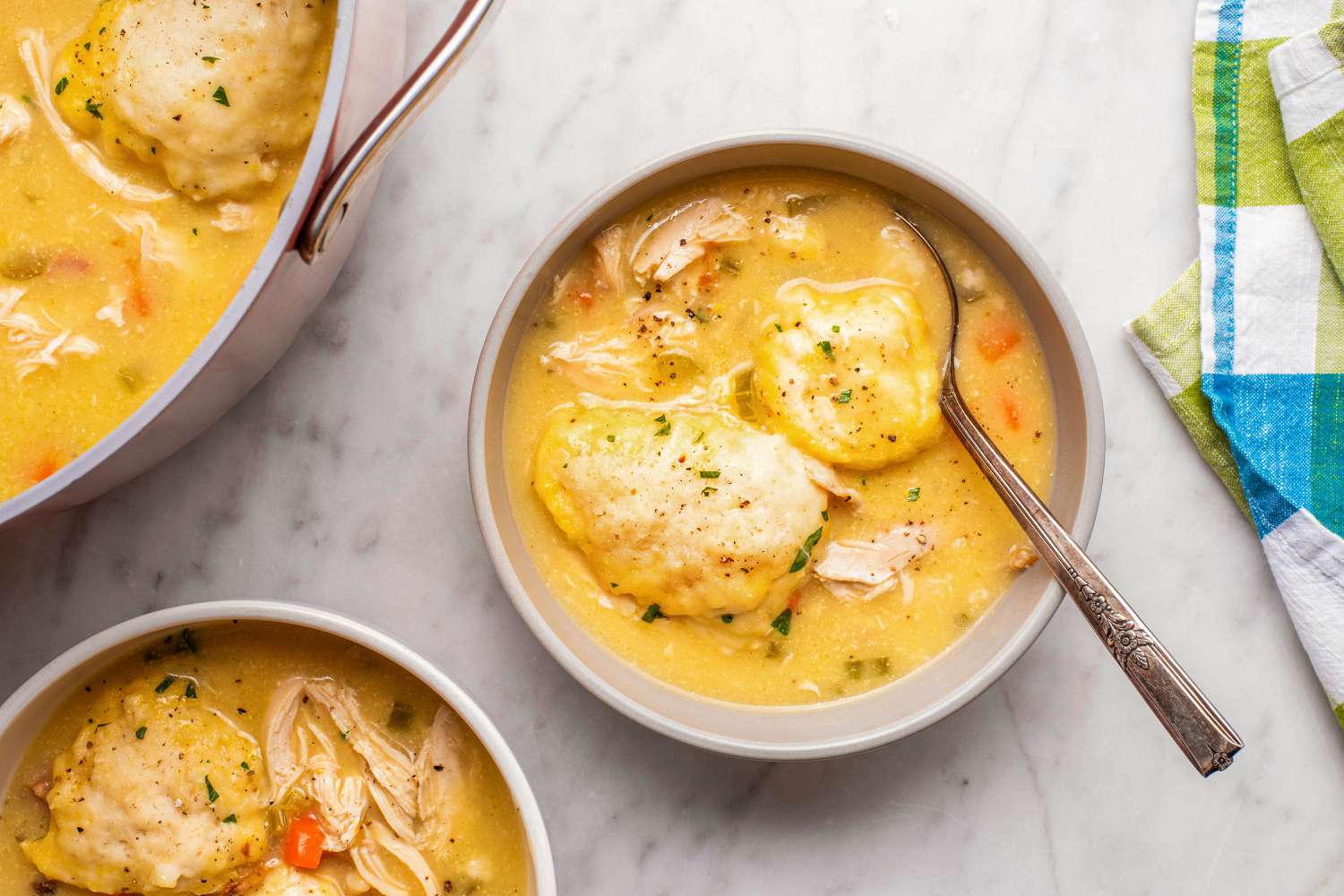 overhead view of bowls of Easy Chicken and Dumplings with spoons