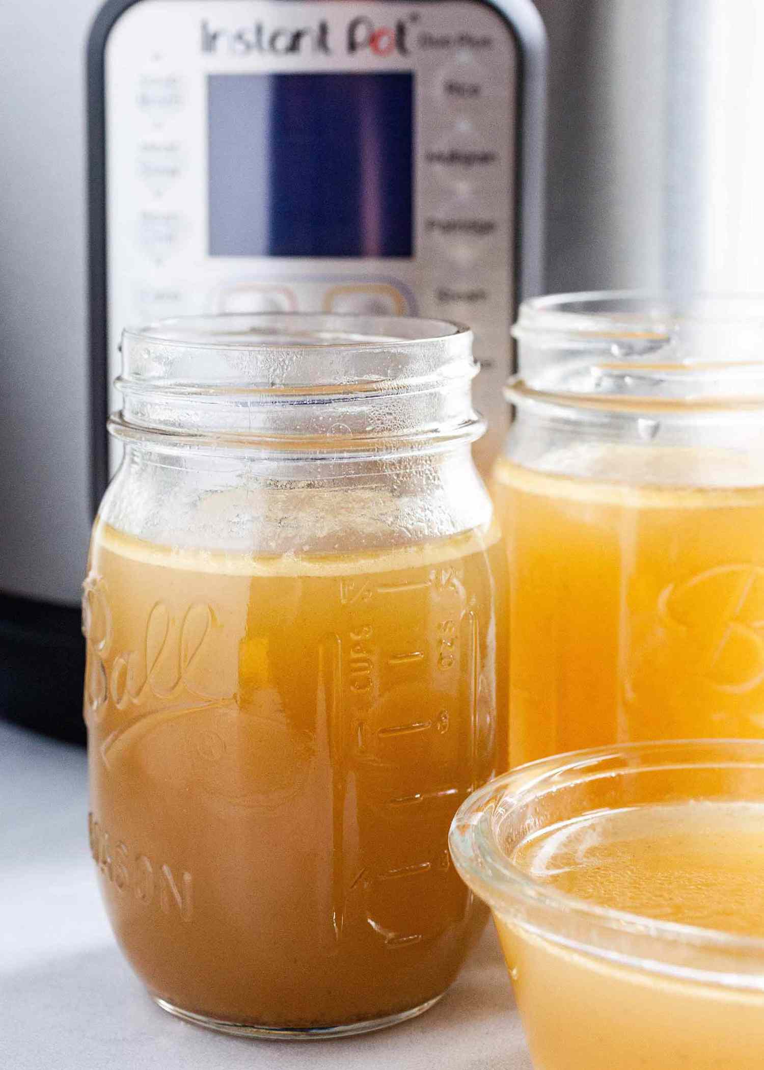 Stock in jars next to Instant Pot