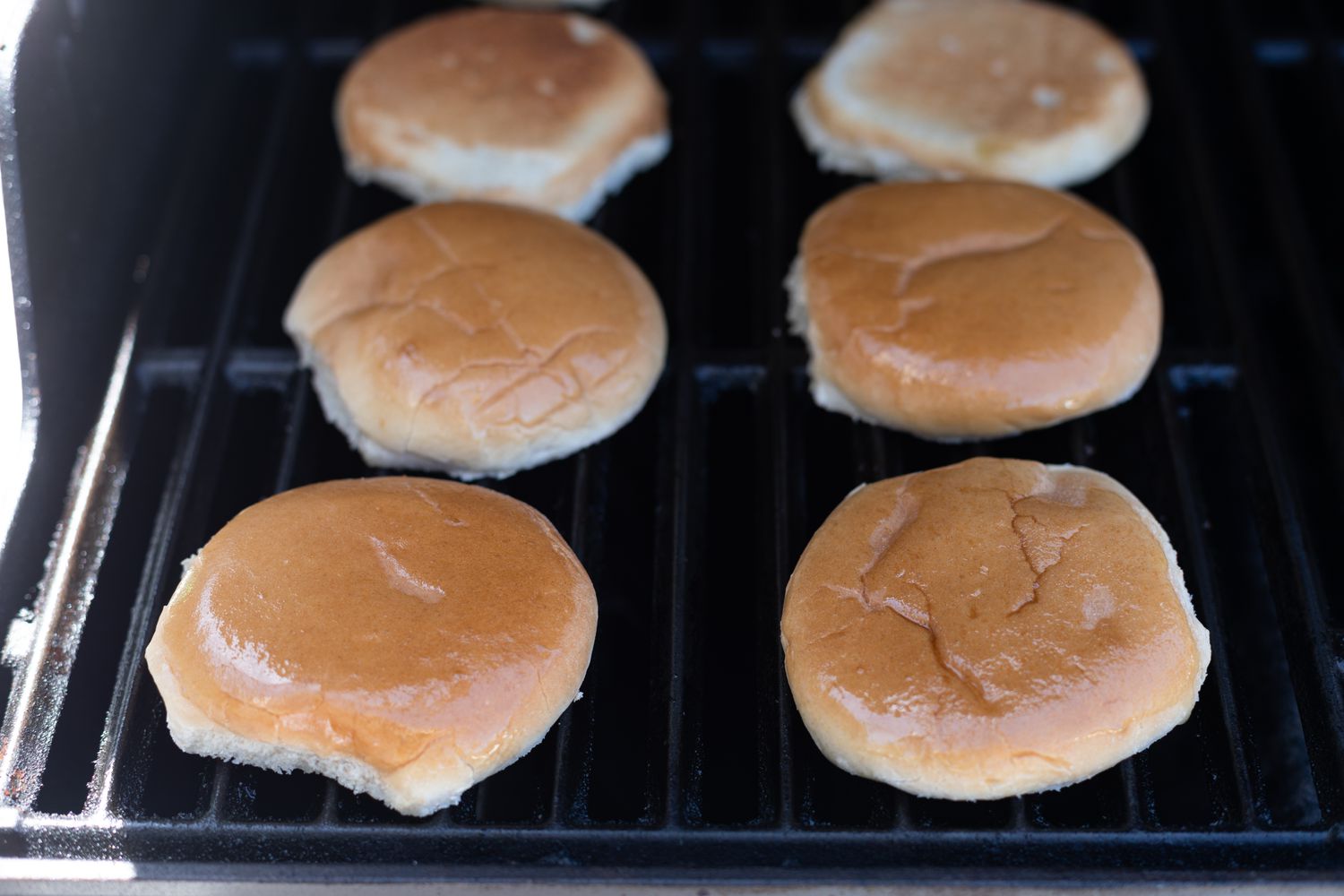 Toasting buns on the grill for mushroom swiss burgers.
