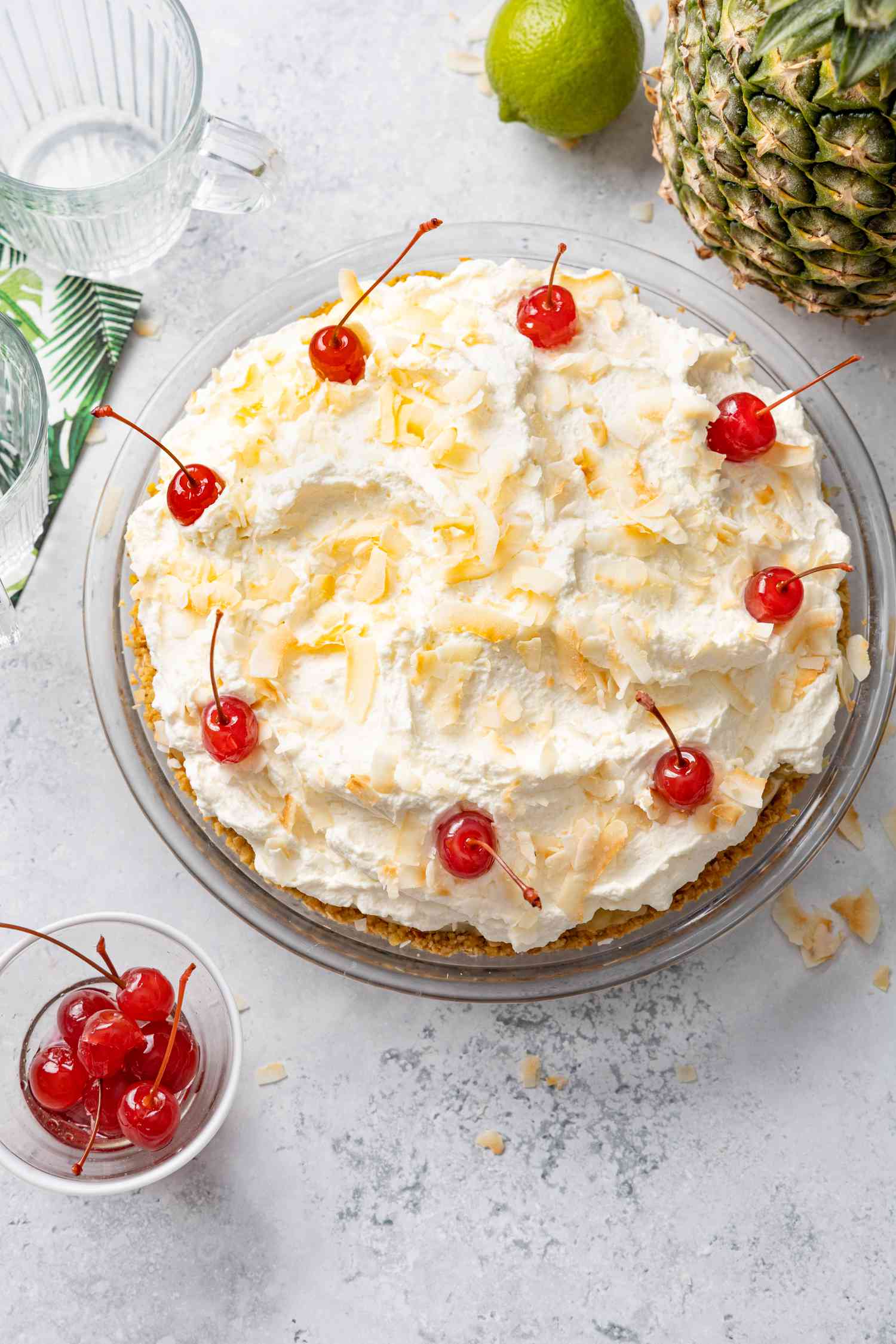 Piña Colada Pie Topped with Toasted Coconut Flakes and Maraschino Cherries