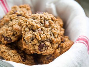 Best Oatmeal Chocolate Chip Cookies in a basket lined with a tea towel