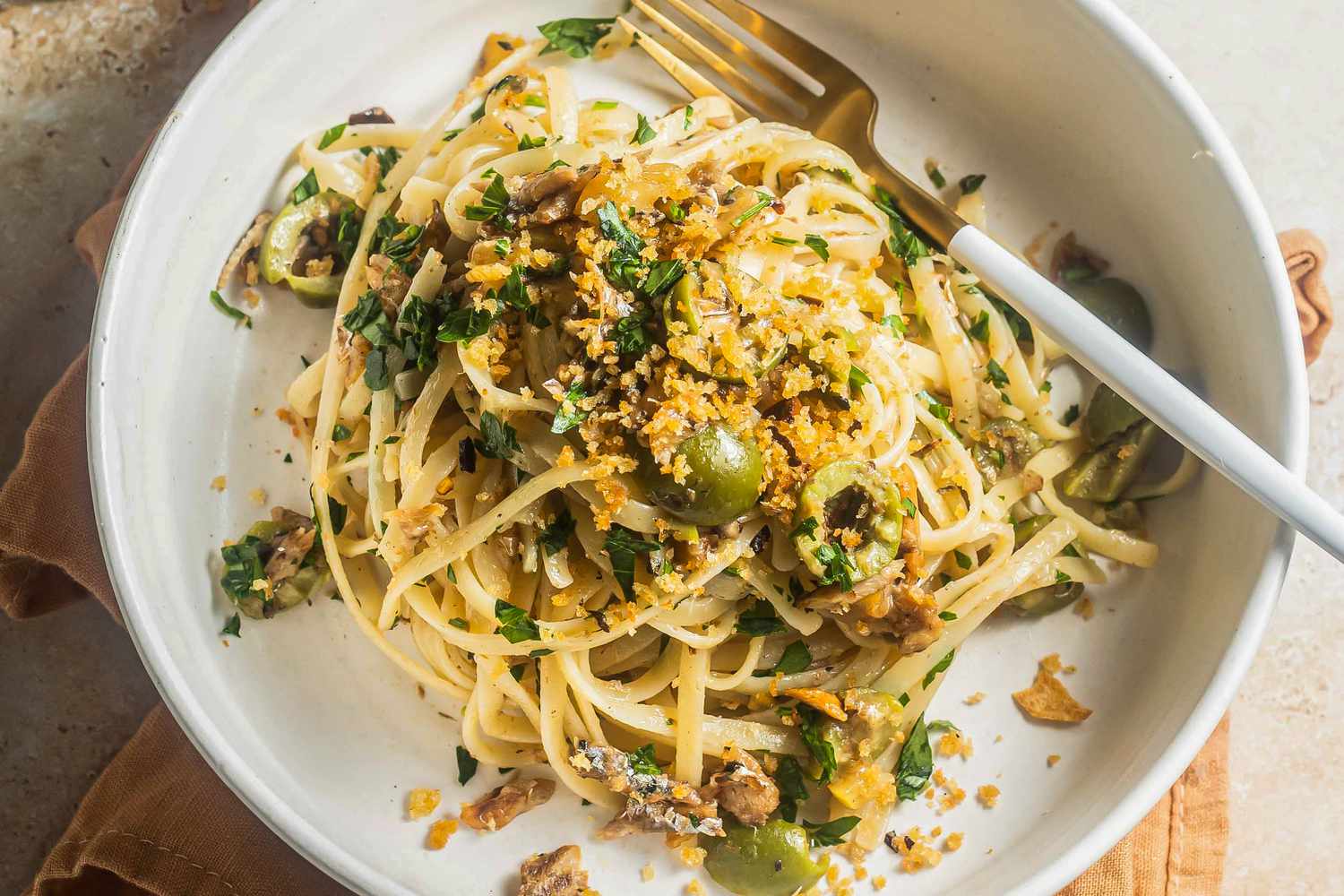 A plate of sardine linguine topped with breadcrumbs