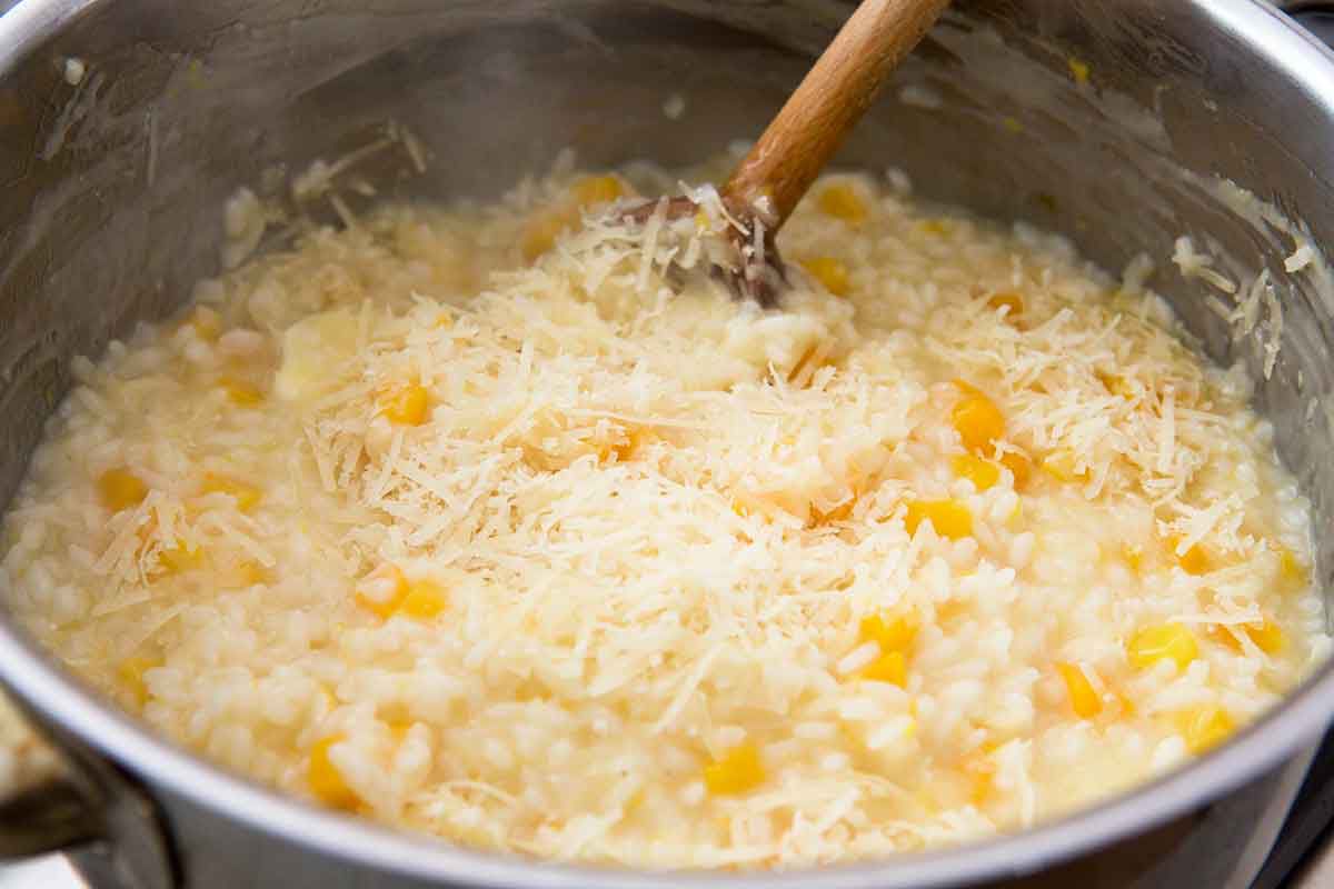 adding Parmesan to pot of butternut squash risotto