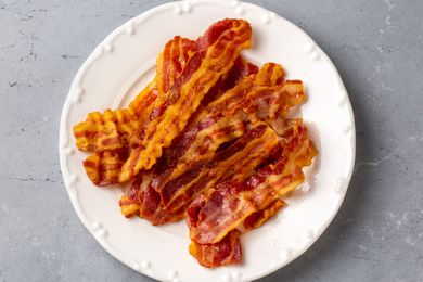 Crispy fried bacon on a white plate