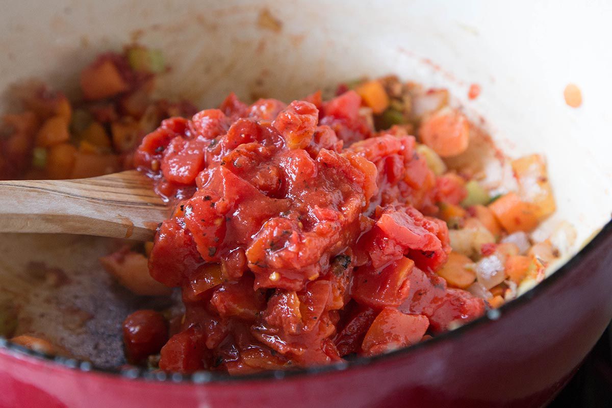 Diced Tomatoes being added to vegetable sauté 