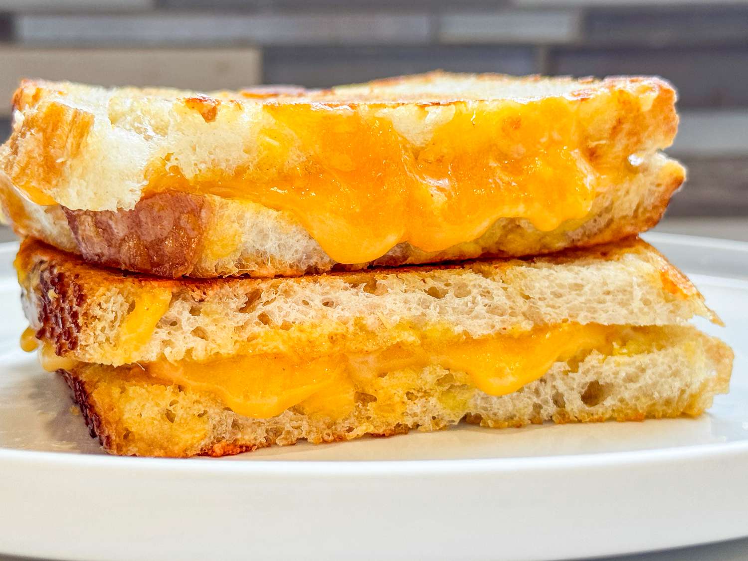 Close up of a grilled cheese sandwich with cheese oozing out