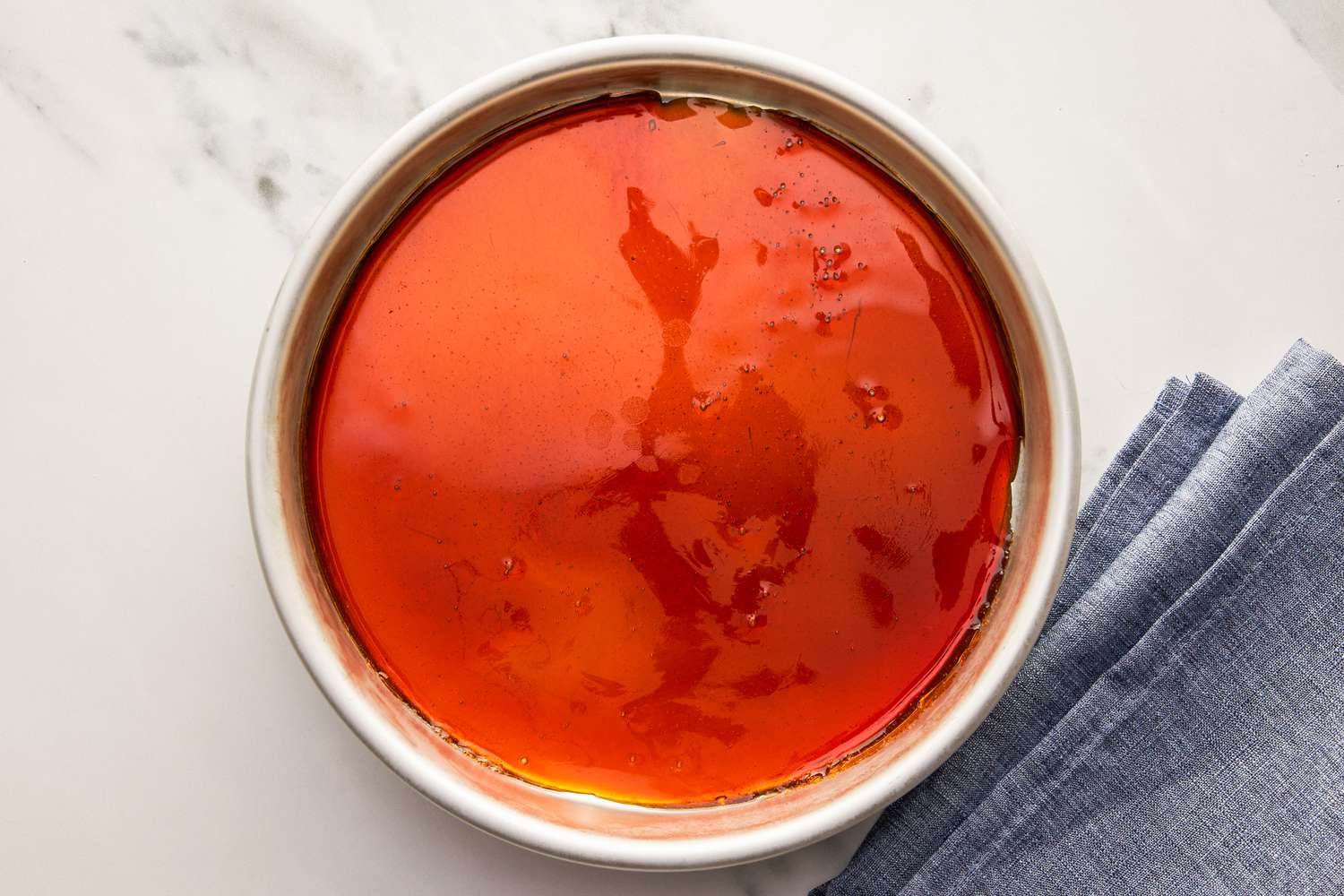melted caramel in a cake pan for flan recipe