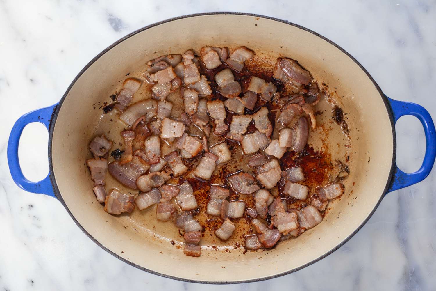 Bacon cooking in Dutch oven.