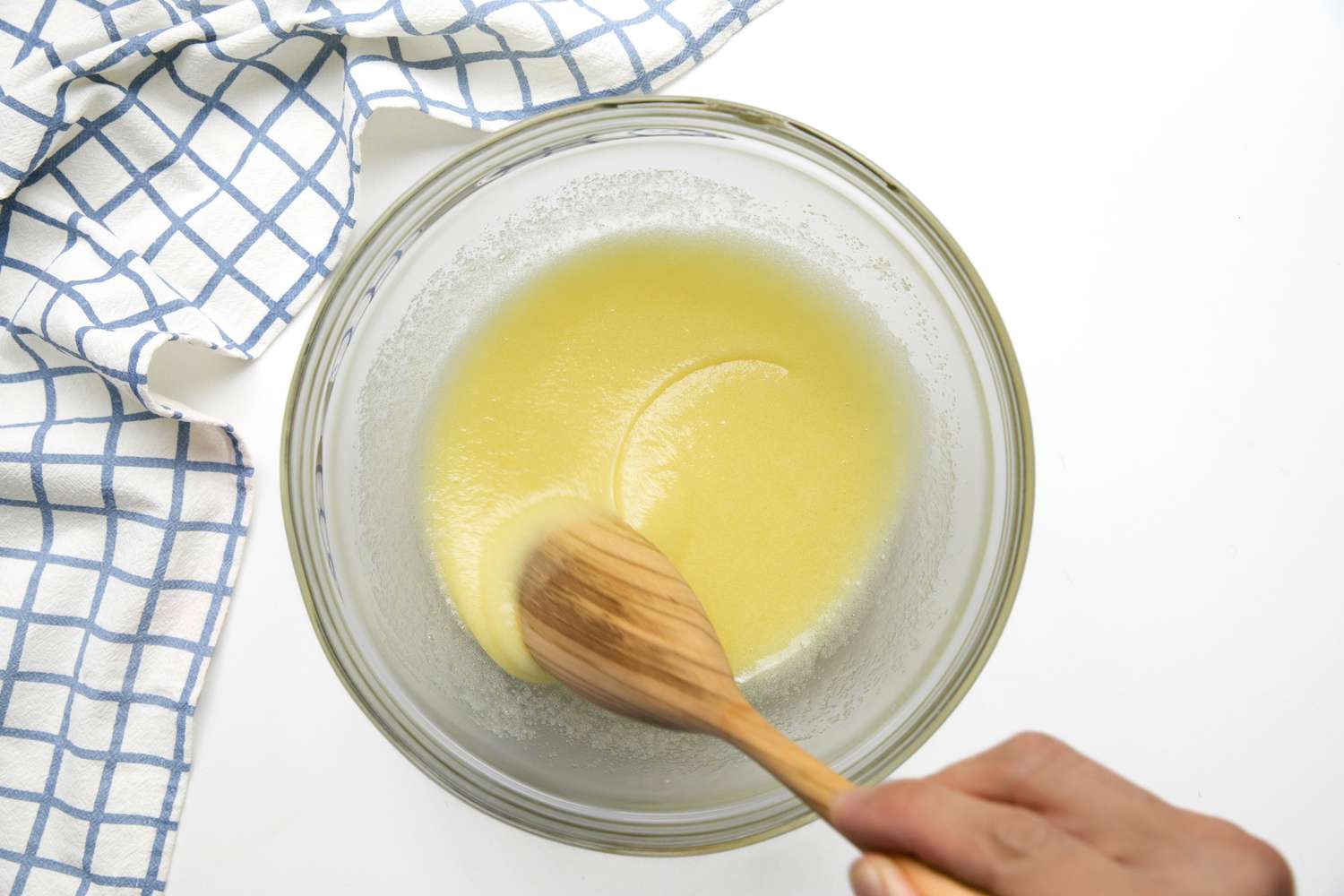 Egg and Sugar Mixed in a Bowl with a Wooden Spoon for Cassava Cake Recipe