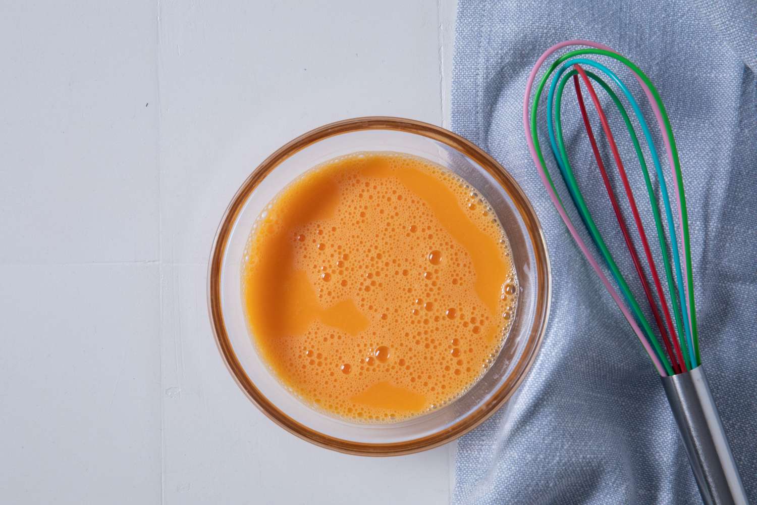 bowl of whisked eggs for batsaria recipe