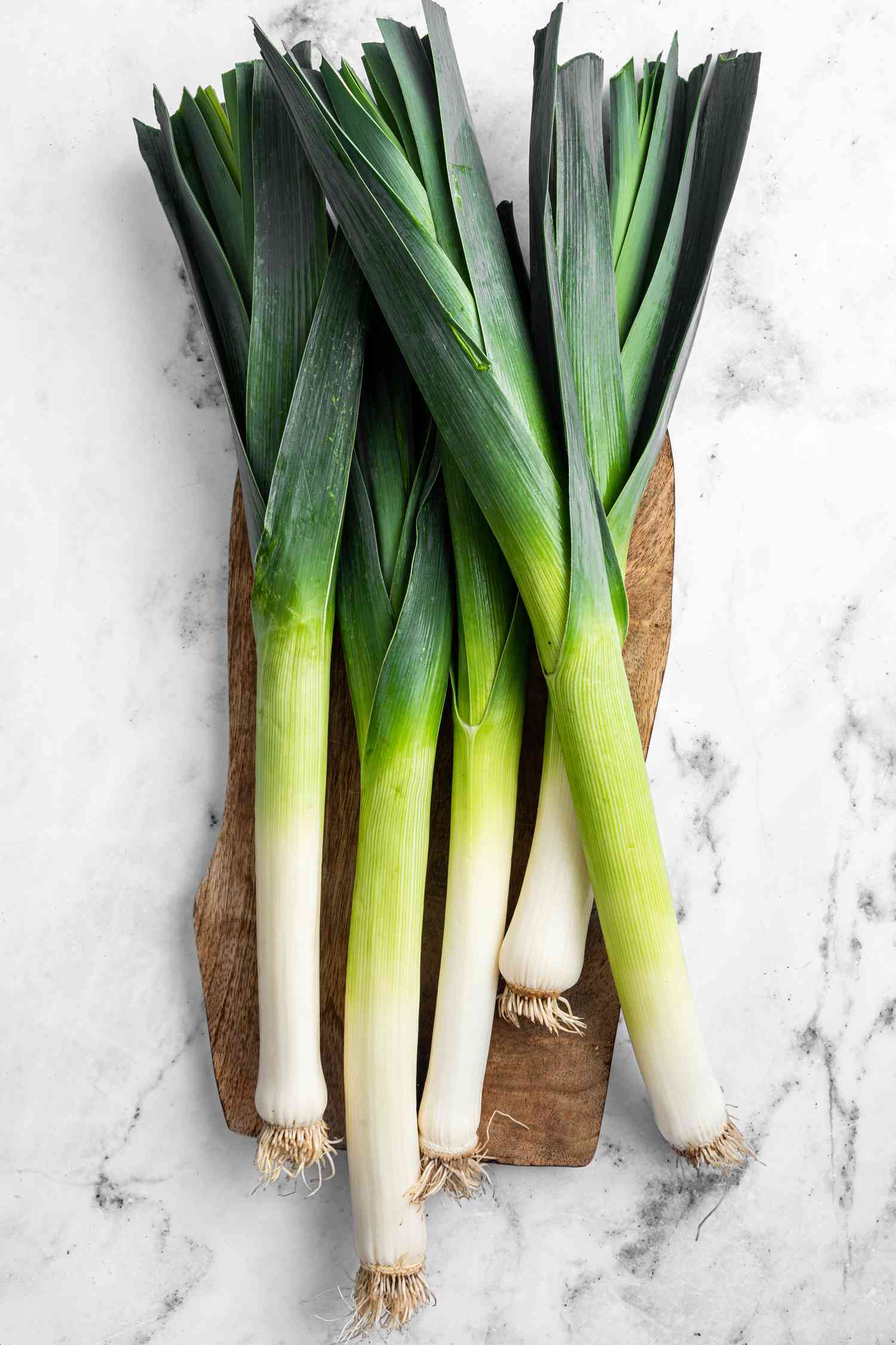 Leeks on a Wooden Board on the Counter