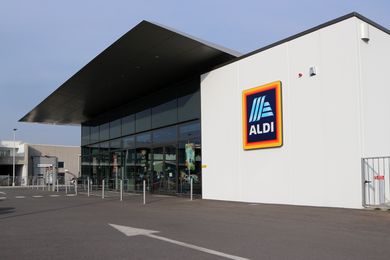 ALDI retail store exterior with a glass storefront and logo sign
