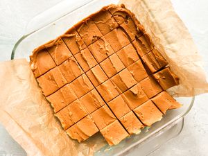 Over head view of a peanut butter fudge cut up in squares in a glass baking dish