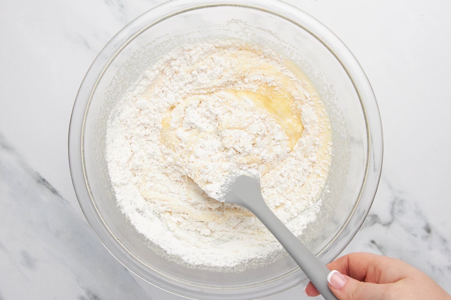 Dry ingredients folded in using a spatula for lazy daisy cake recipe 