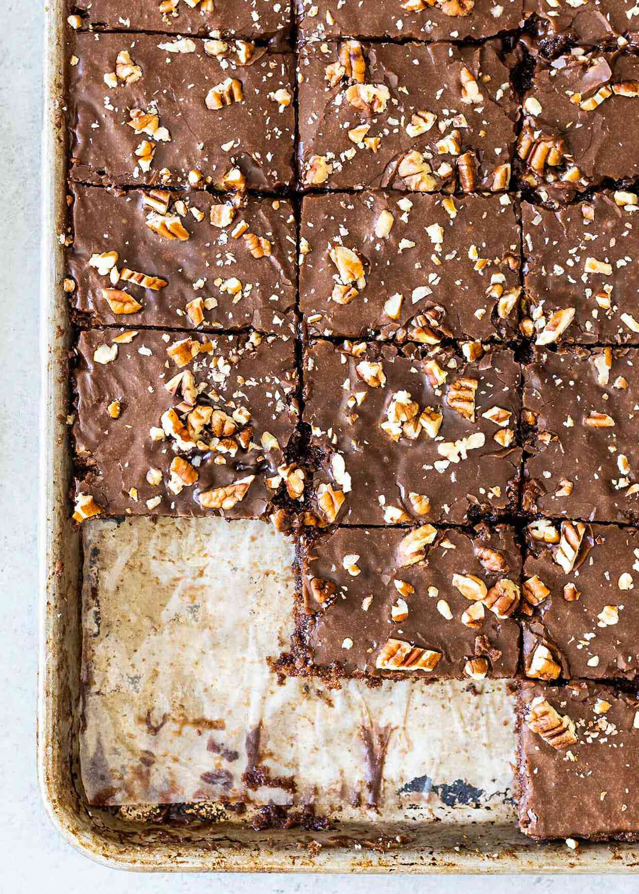 Texas sheet cake with a few slices missing.