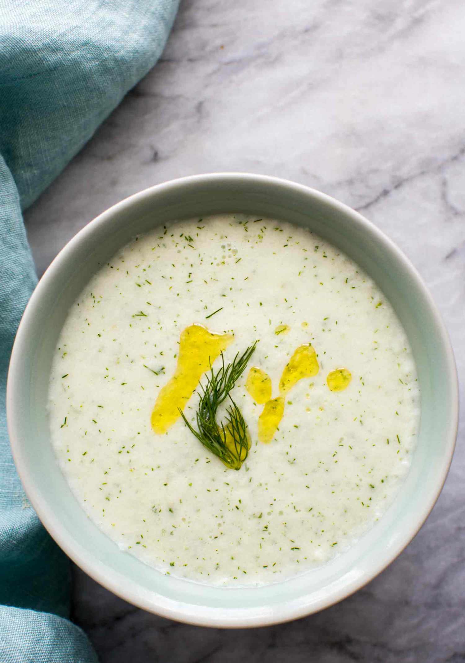 A bowl of cold cucumber soup, ready to serve and eat.
