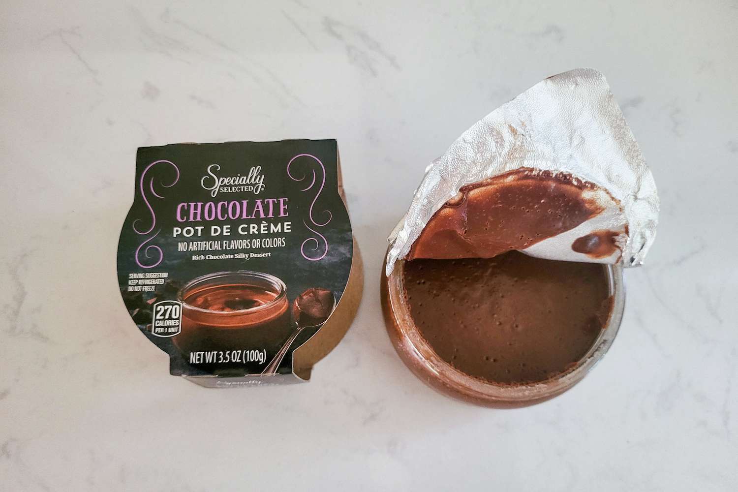 A store bough chocolate pot de crème jar from ALDI, with the lid opened up