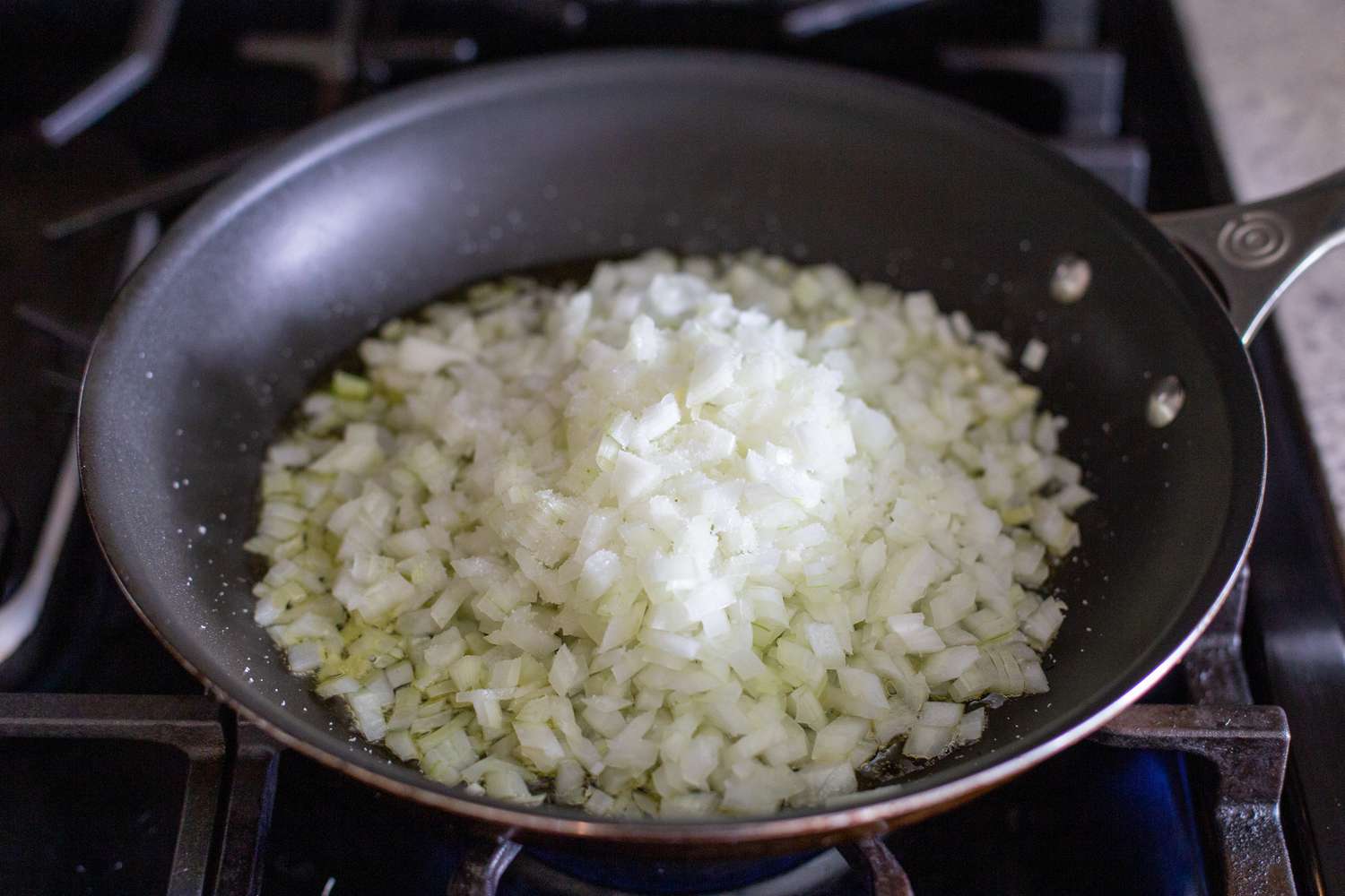 Small dice onions in pan to make caramelized onions for kreplach filling