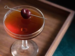 Manhattan cocktail with cherry garnish