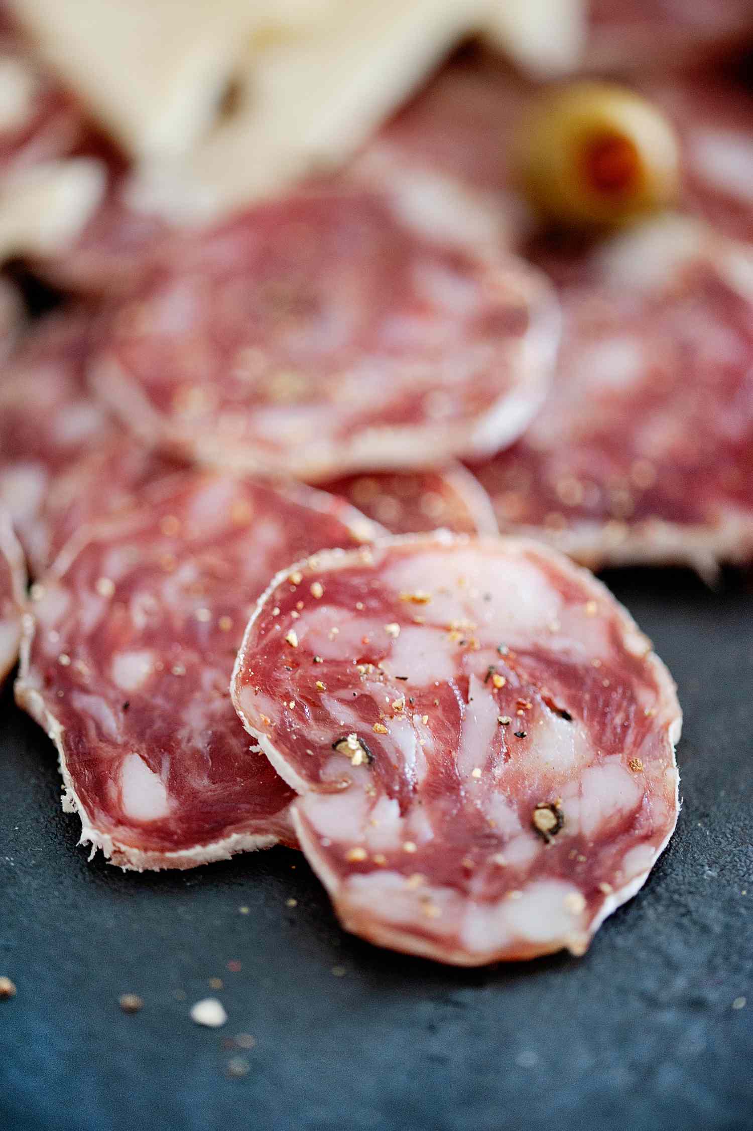 Sliced soppressata on slate board