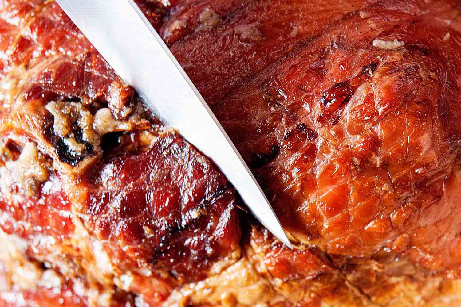 Brown Sugar Glazed Ham - scoring the fat of a ham with a knife