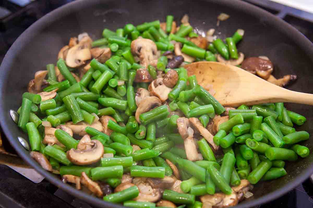 green beans and mushrooms in a skillet