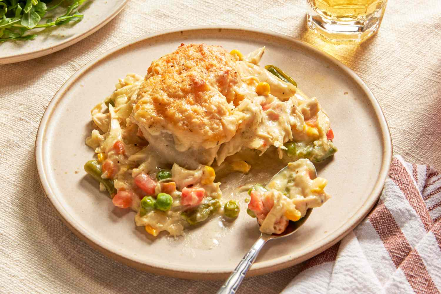 Serving of Chicken Cobbler With Cheddar Bay Biscuit Top on a plate 